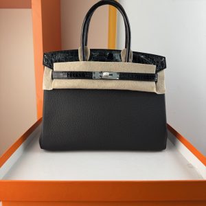 TouchBK; Size 30, Black and Silver  Togo leather and high-gloss crocodile leather, hand-sewn waxed thread  All-steel hardware, goat leather lining