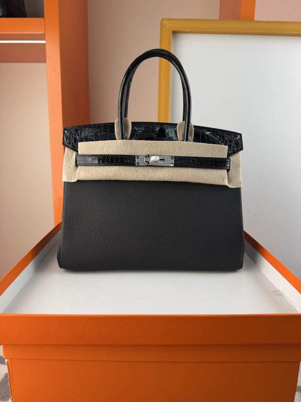 TouchBK; Size 30, Black and Silver  Togo leather and high-gloss crocodile leather, hand-sewn waxed thread  All-steel hardware, goat leather lining