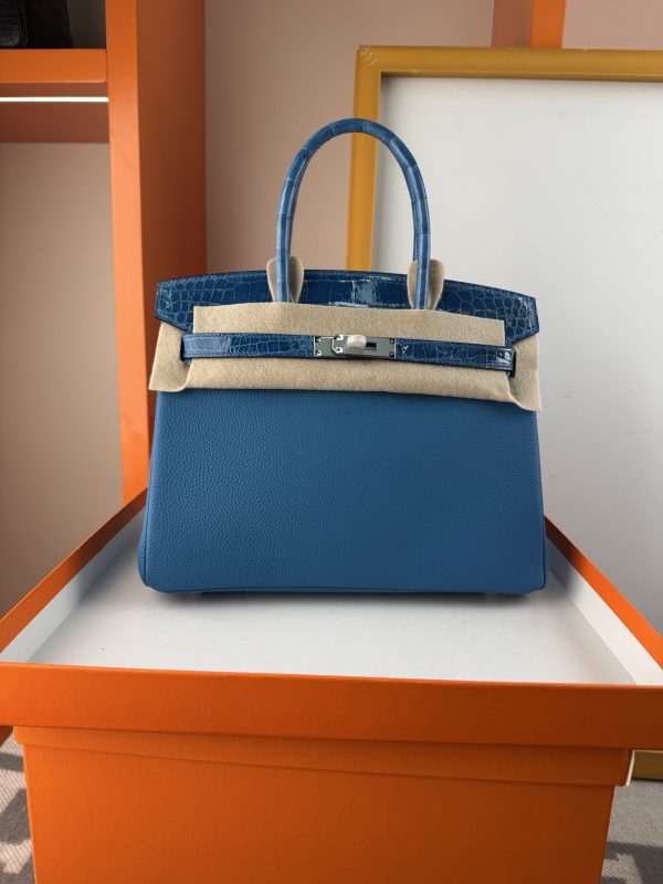 TouchBK; Size 30 Paradise Blue  Togo leather with high-gloss crocodile leather, hand-sewn waxed thread  All-steel hardware, goat leather lining